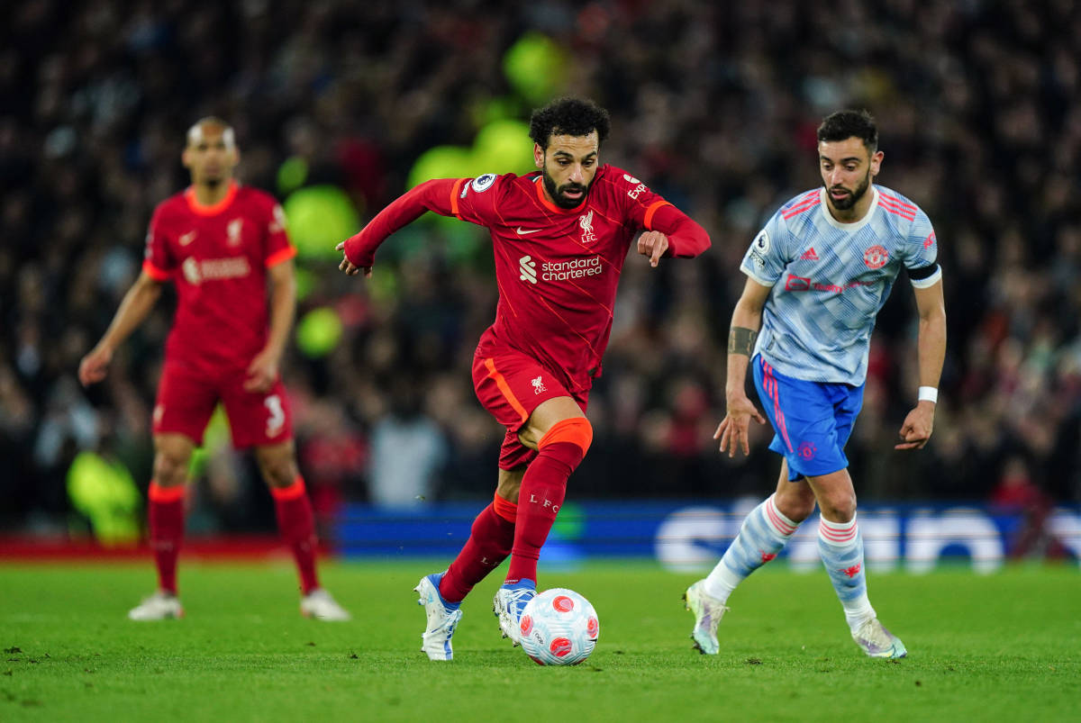 Mo Salah (center) is pictured dribbling away from Bruno Fernandes during Liverpool's 4-0 win over Manchester United in April 2022