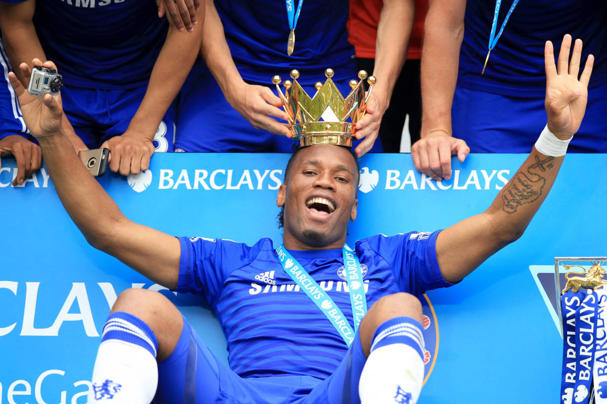Didier Drogba pictured celebrating with the top half of the Premier League trophy after winning it for a fourth time with Chelsea in 2015