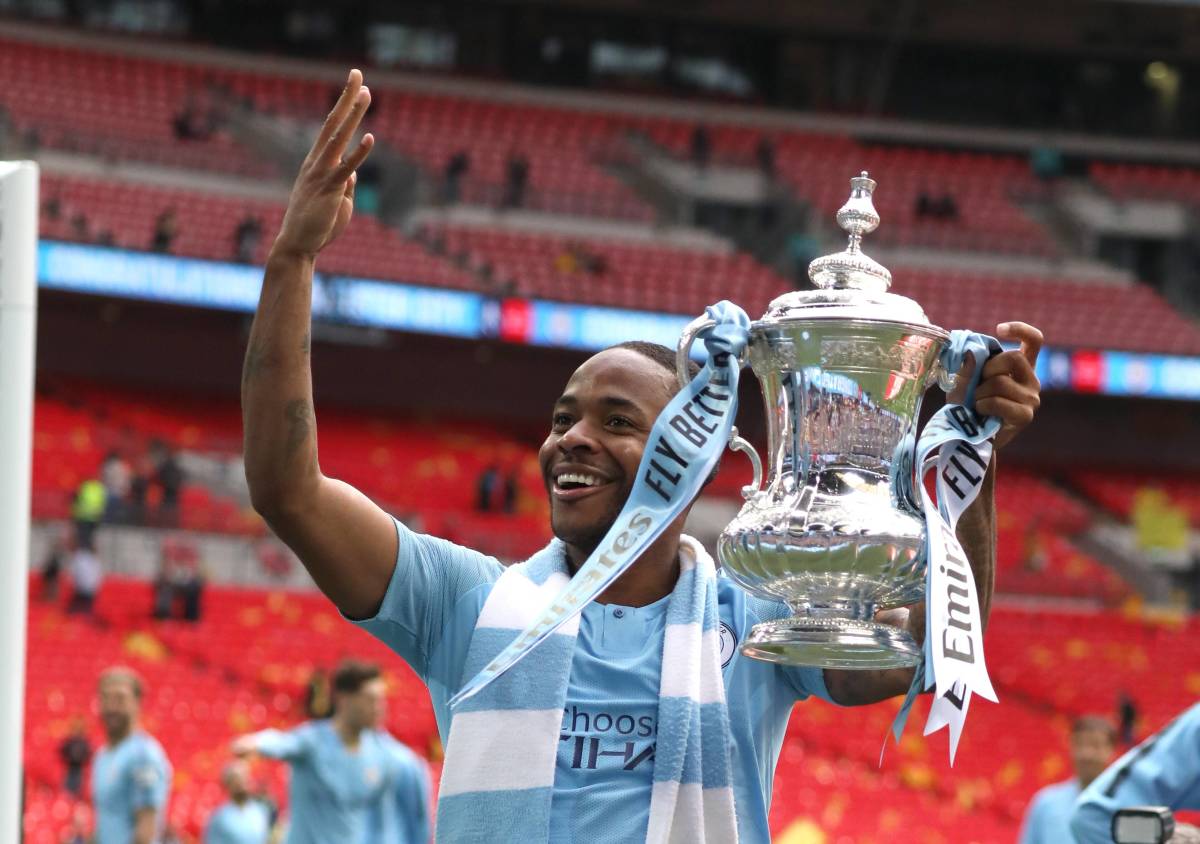 Raheem Sterling pictured celebrating with the FA Cup trophy after starring in Manchester City's 6-0 win over Watford in the 2019 final