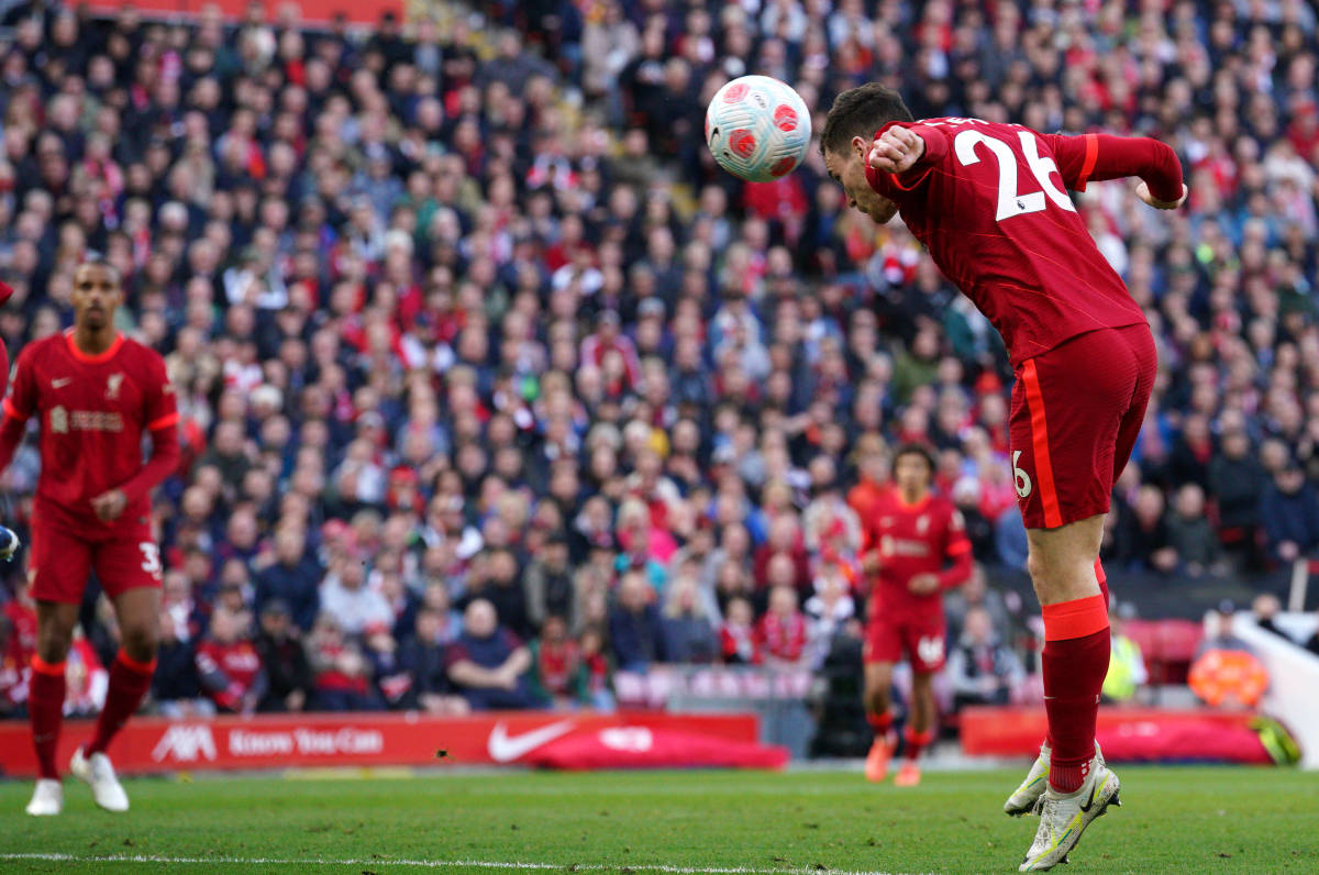 Andy Robertson (right) heads the ball to score for Liverpool against Everton at Anfield in April 2022