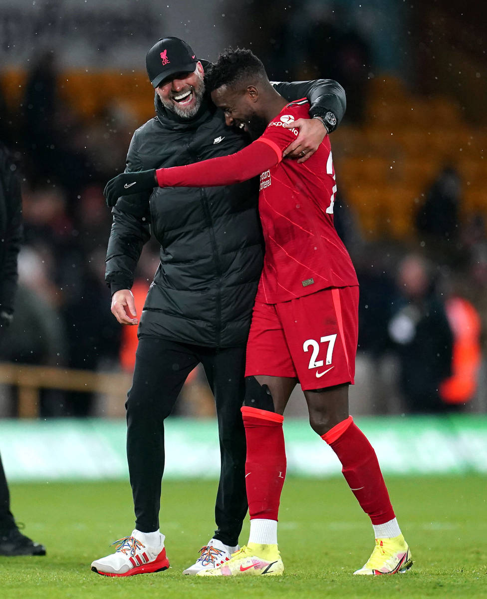 Jurgen Klopp and Divock Origi (right) pictured hugging after the striker scored a last-minute winner for Liverpool against Wolves in December 2021