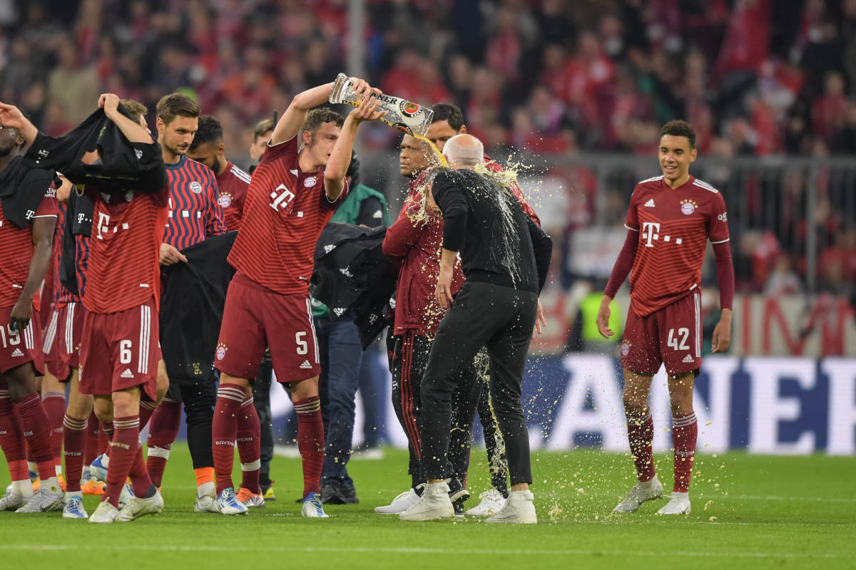Benjamin Pavard (No 5) pours beer over the head of Bayern Munich manager Julian Nagelsmann