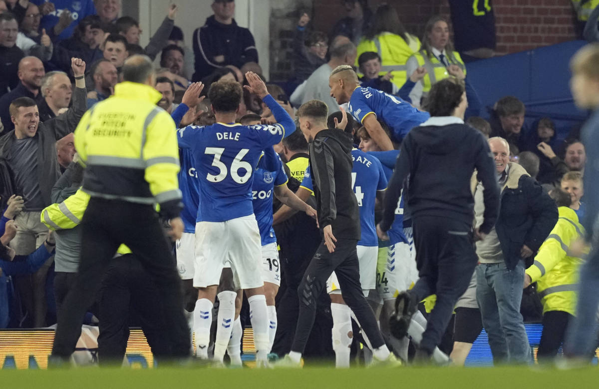 Everton players and fans celebrate the goal which saw them avoid relegation from the Premier League in May 2022