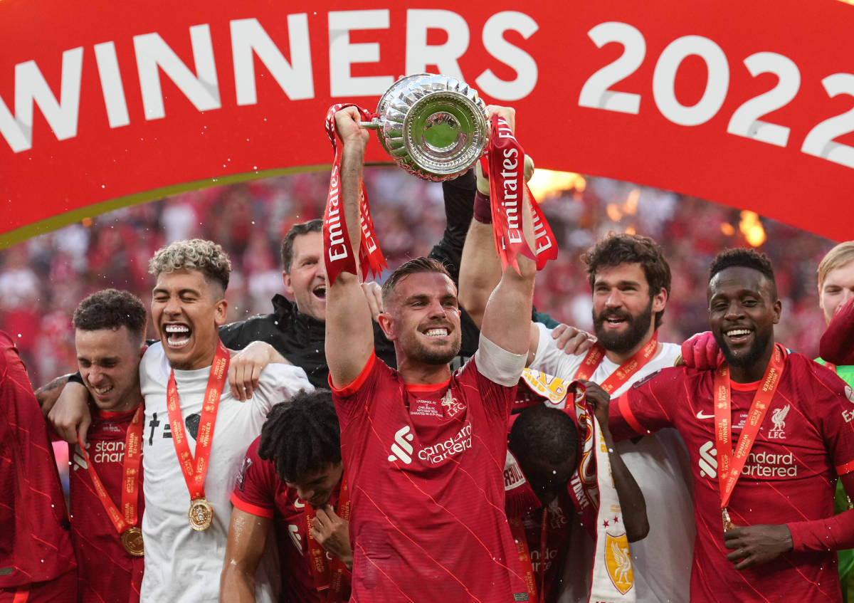 Liverpool captain Jordan Henderson pictured lifting the FA Cup trophy after his side beat Chelsea on penalties in the 2022 final