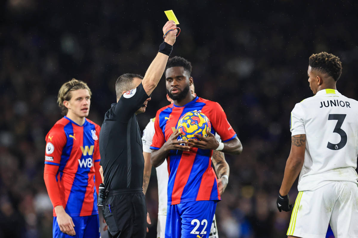 Junior Firpo (right) pictured receiving a yellow card in Leeds United's game against Crystal Palace in November 2021