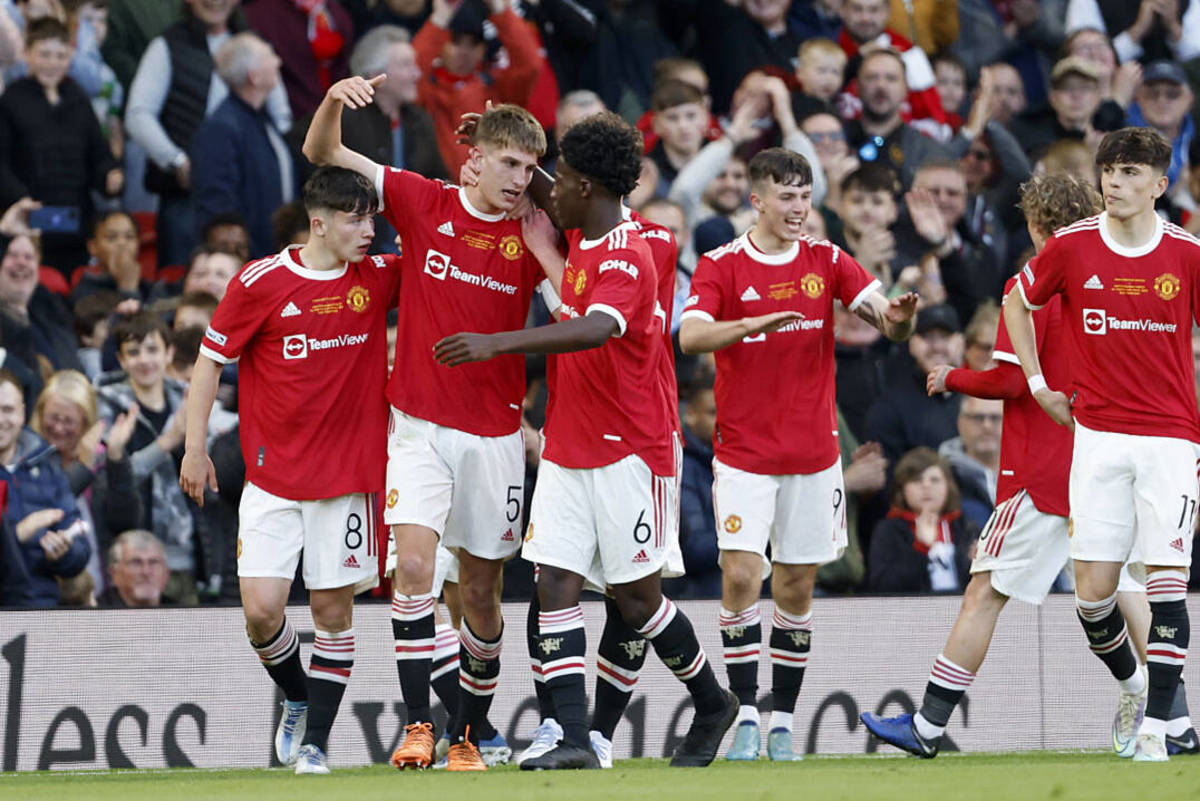 Players from Manchester United's Under 18 team pictured celebrating together after a goal from captain Rhys Bennett (No.5, second left) in the 2022 FA Youth Cup final against Nottingham Forest