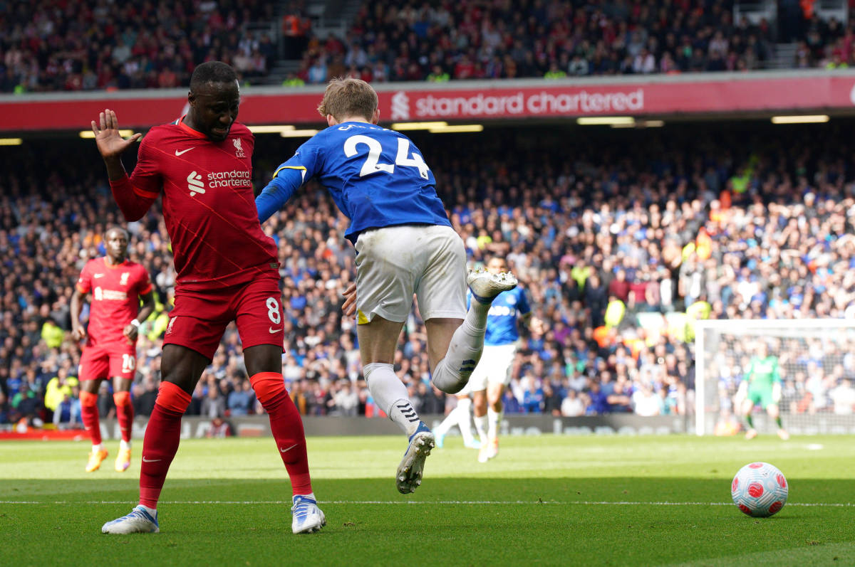 Everton midfielder Anthony Gordon falls over in the Liverpool penalty area before being shown a yellow card for diving