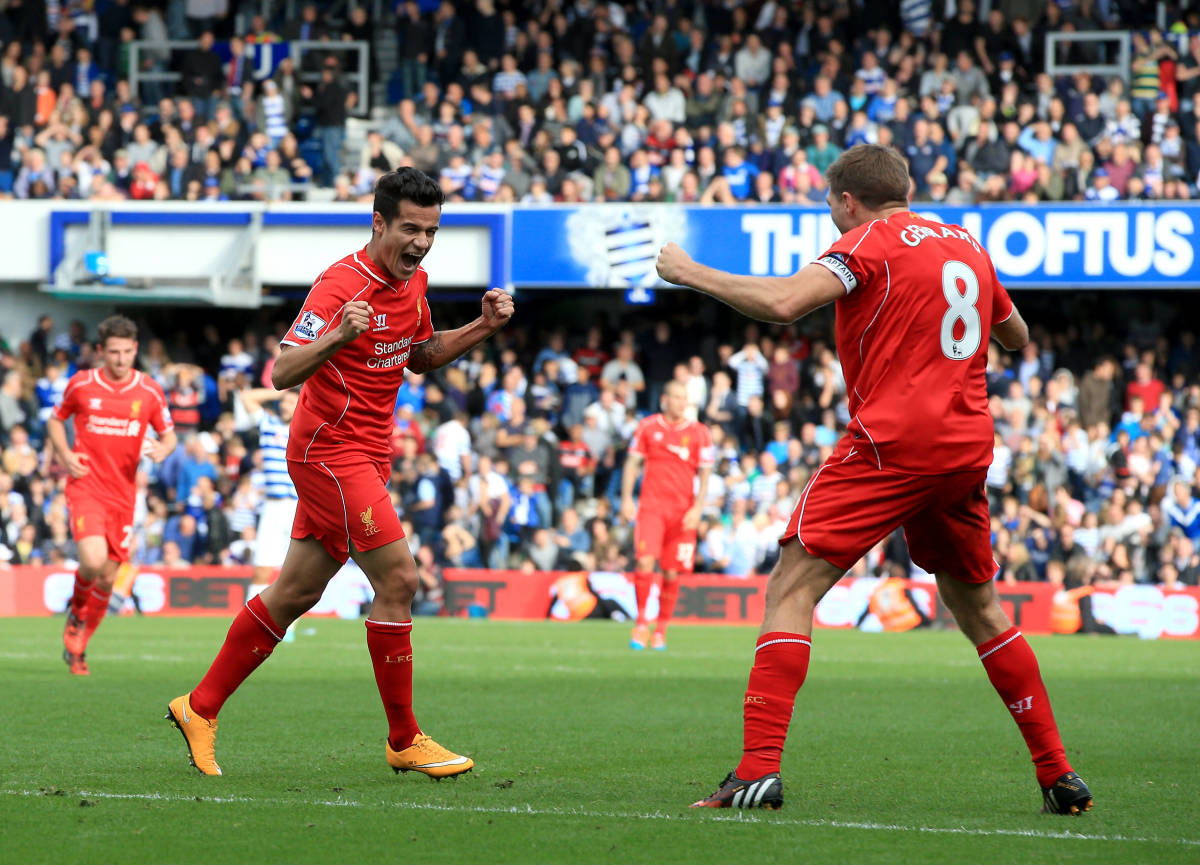 Philippe Coutinho celebrates with Steven Gerrard after scoring for Liverpool at QPR in 2014