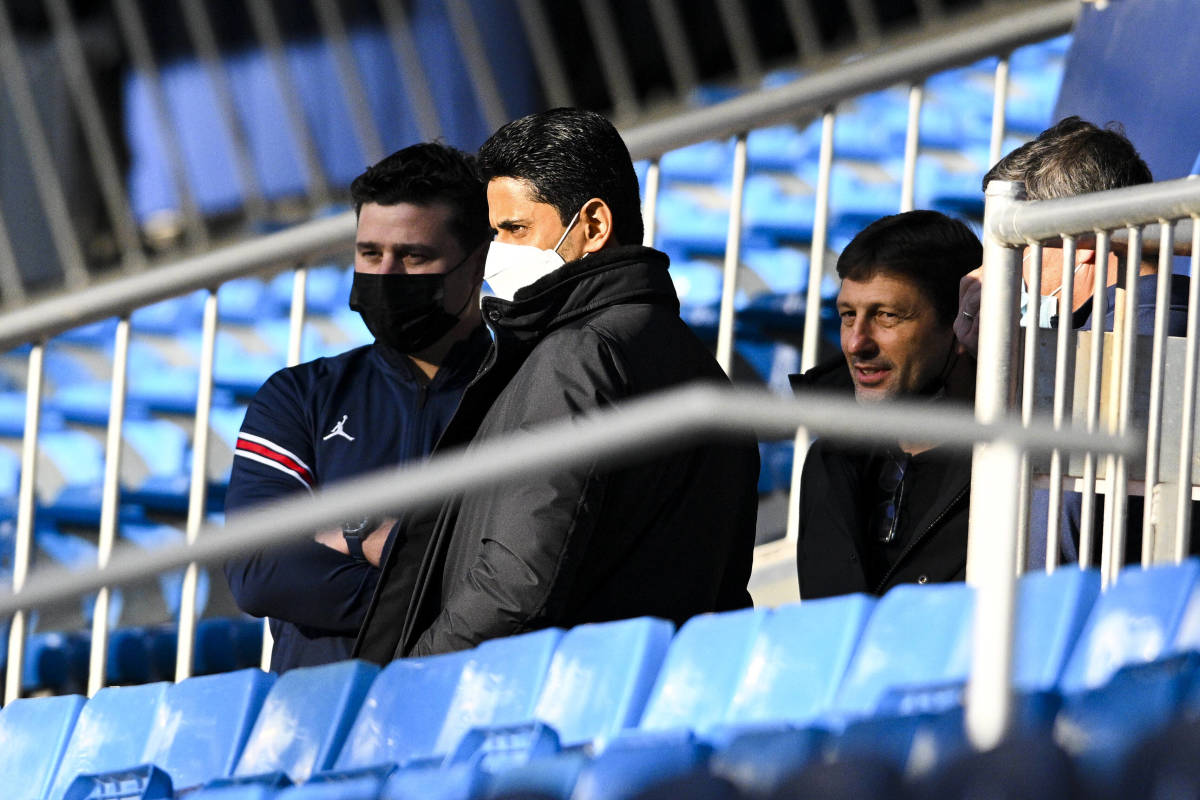 PSG president Nasser Al-Khelaifi (center) pictured with manager Mauricio Pochettino (left) a day before their team's game away to Real Madrid