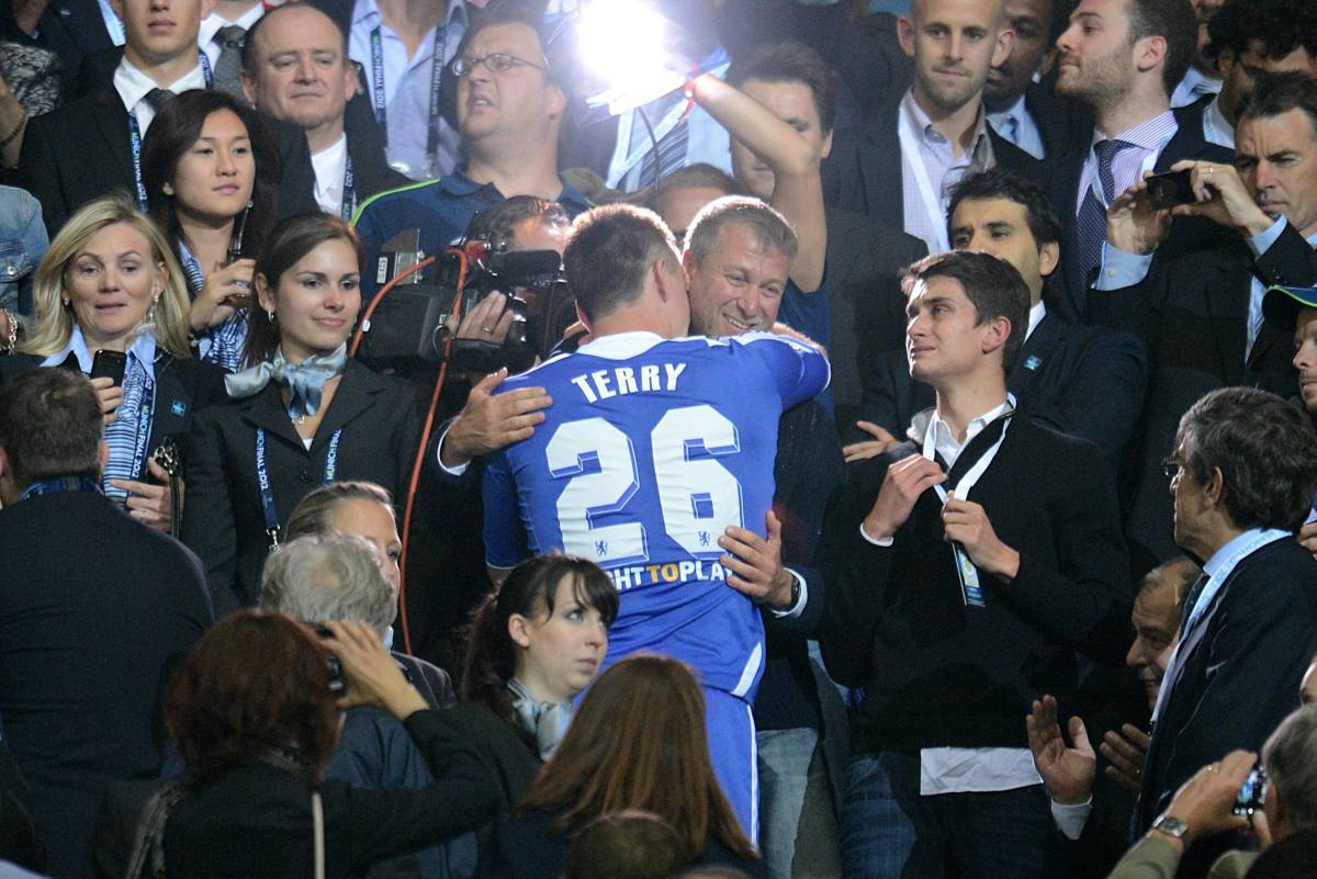 Chelsea owner Roman Abramovich is hugged by team captain John Terry after winning the Champions League in 2012