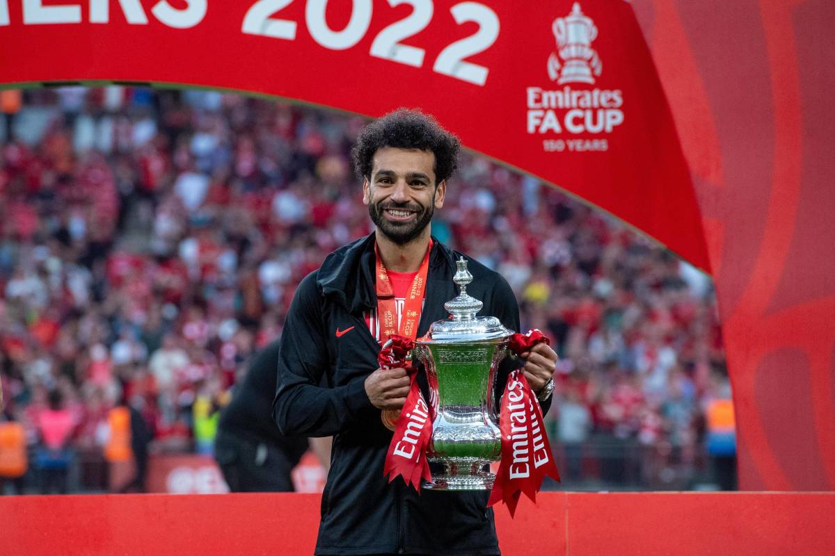 Liverpool star Mo Salah pictured lifting the FA Cup trophy in May 2022 after limping off in the 33rd minute of the final against Chelsea