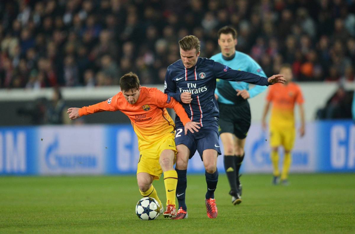 David Beckham pictured in action for PSG against Lionel Messi and Barcelona in 2013