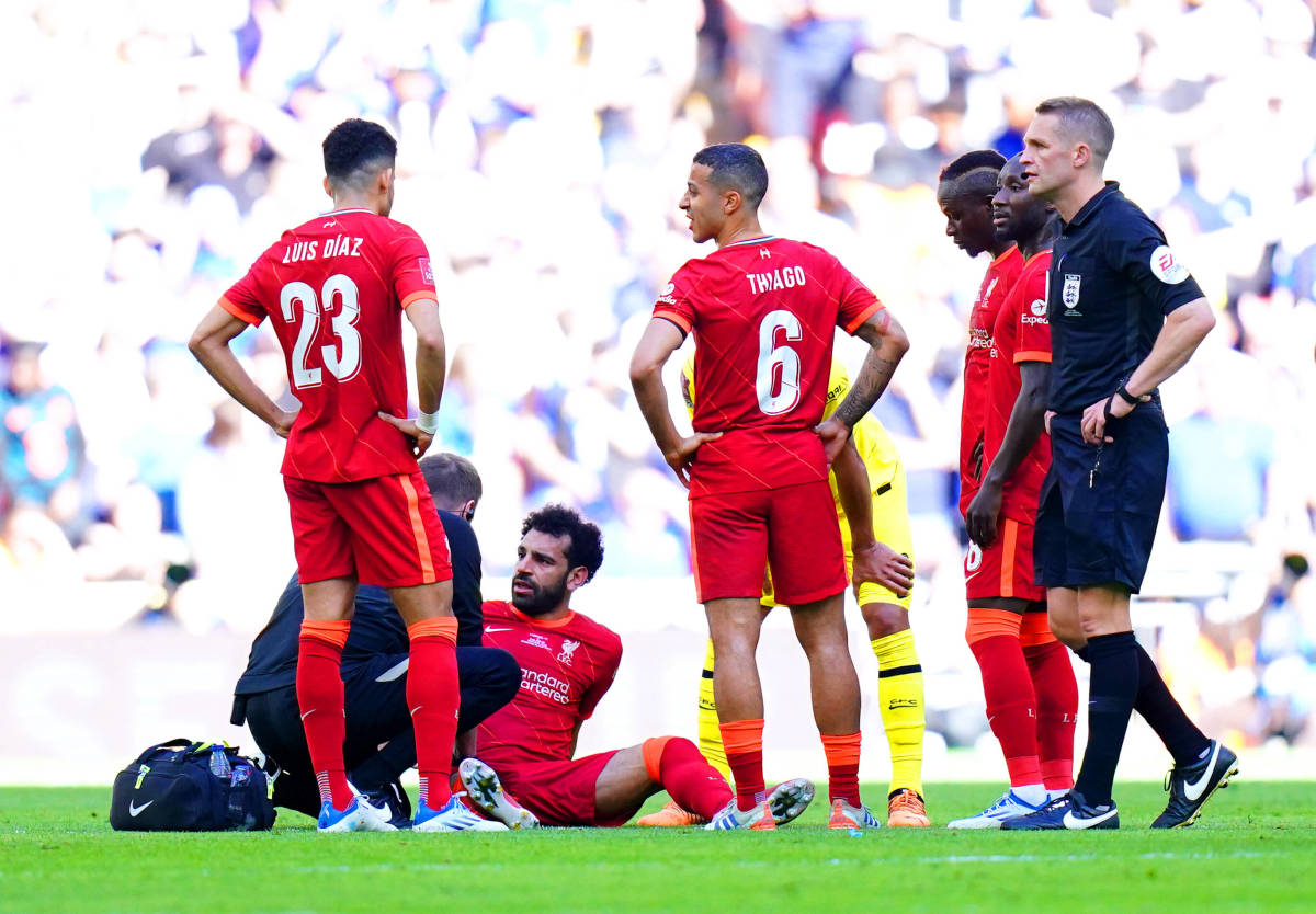 Liverpool star Mo Salah pictured sat on the turf at Wembley Stadium receiving treatment for an injury which ended his appearance in the 2022 FA Cup final prematurely