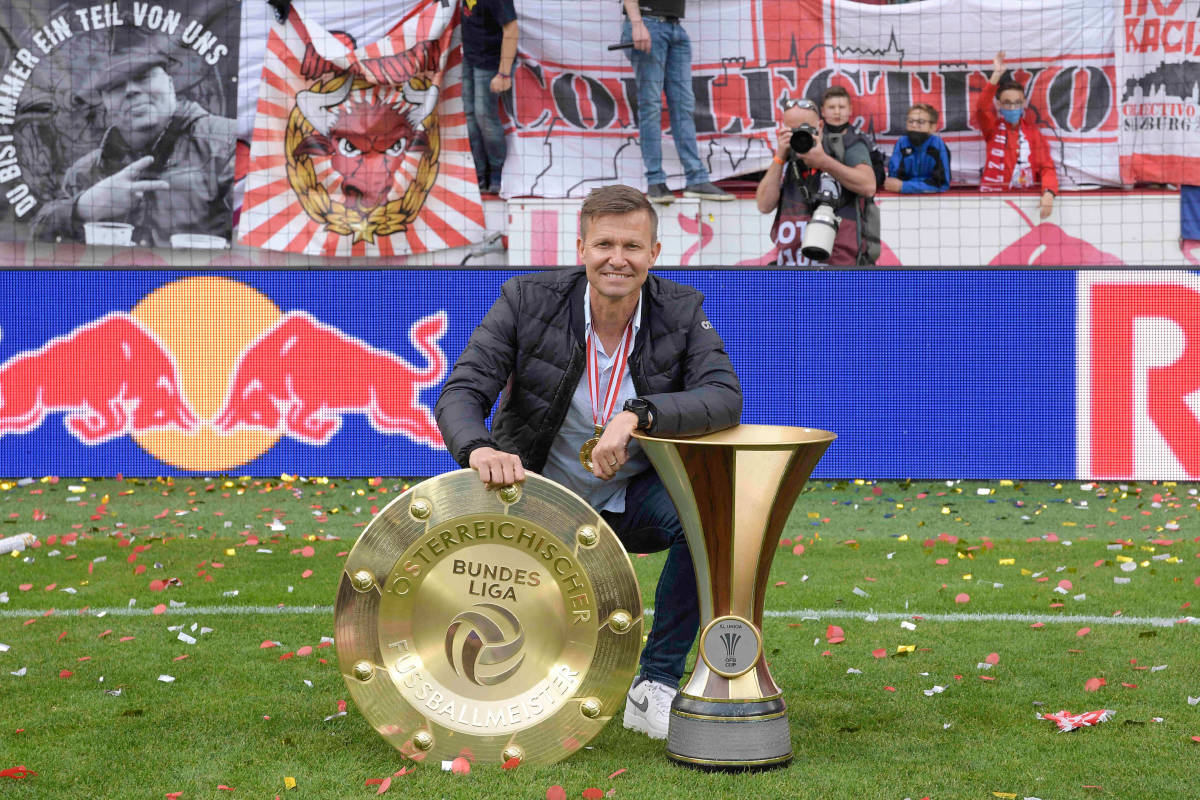 Red Bull Salzburg manager Jesse Marsch pictured posing with two trophies in 2021, after winning both the Austrian Bundesliga and Austrian Cup for the second season in a row