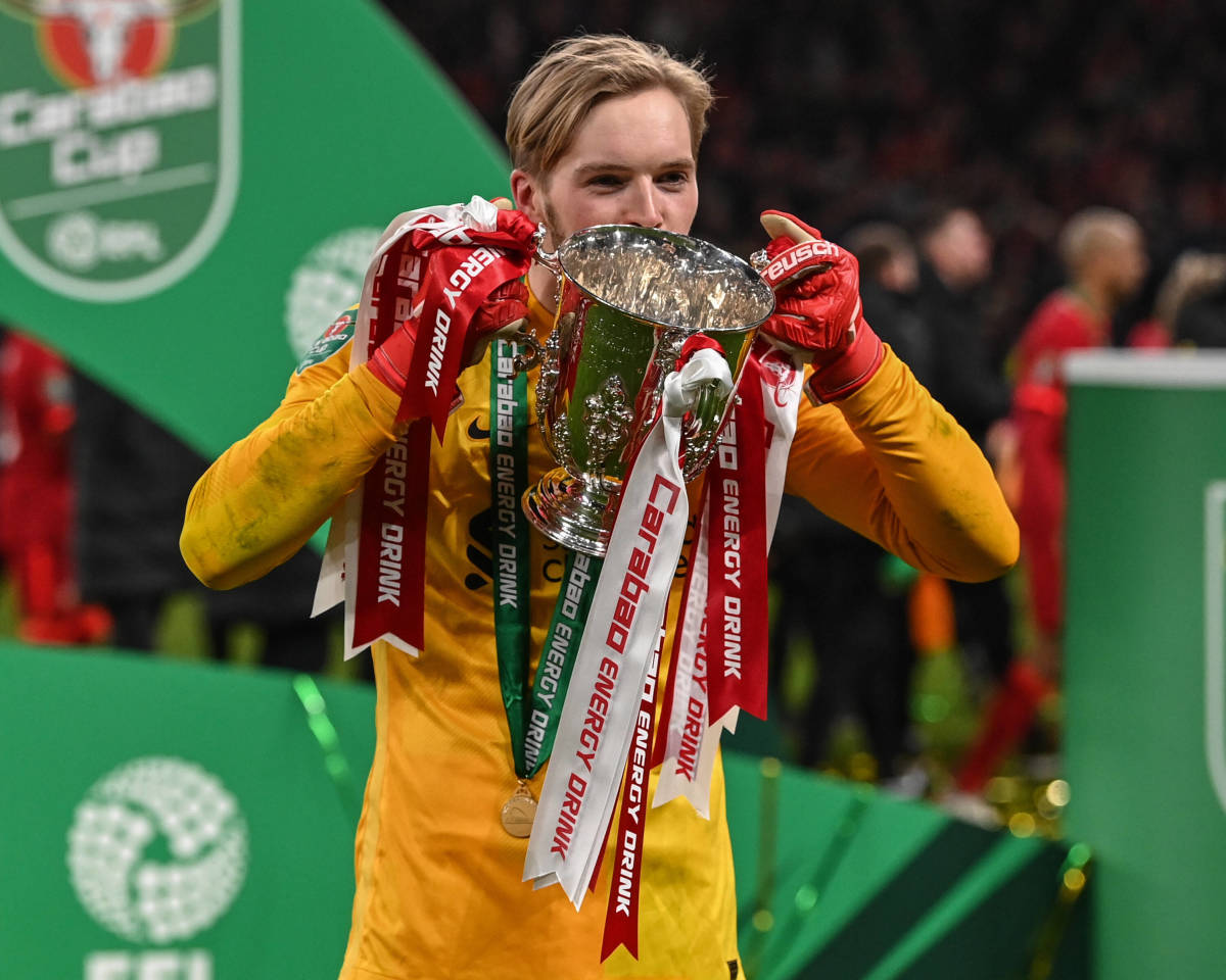 Caoimhin Kelleher kisses the EFL Cup trophy after starring for Liverpool in their victory over Chelsea