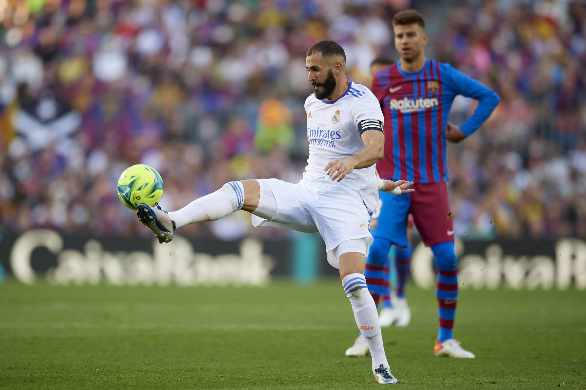 Karim Benzema and Gerard Pique (right) pictured in action during October 2021's Clasico which saw Real Madrid beat Barcelona 2-1 at the Camp Nou