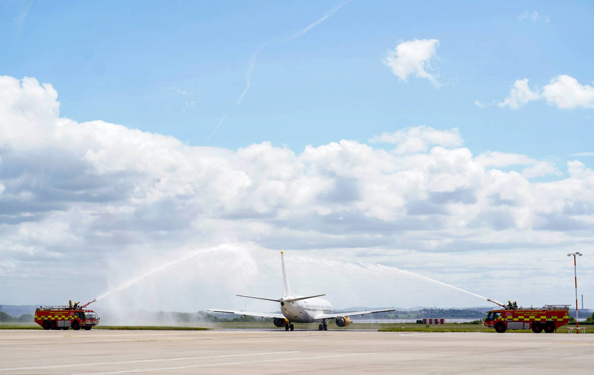 A plane carrying the Liverpool team to Paris for the Champions League final is pictured being given a water salute by the fire brigade at John Lennon Airport