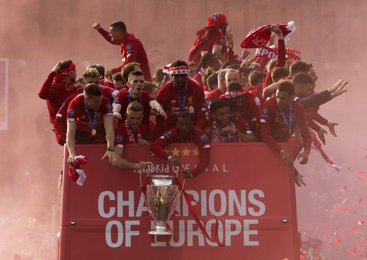 Liverpool players pictured celebrating their 2019 Champions League triumph with an open-top bus parade
