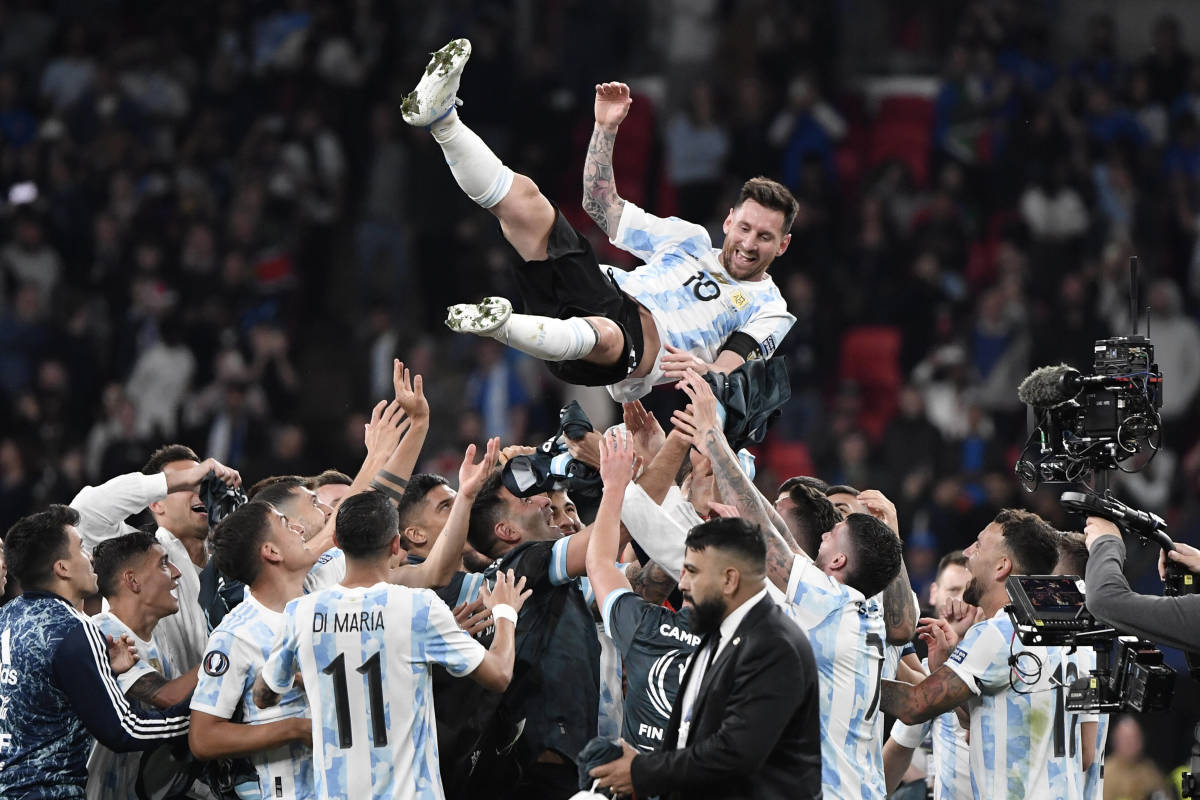 Lionel Messi pictured being thrown into the air by his Argentina teammates after their 3-0 in over Italy in the Finalissima at Wembey in June 2022