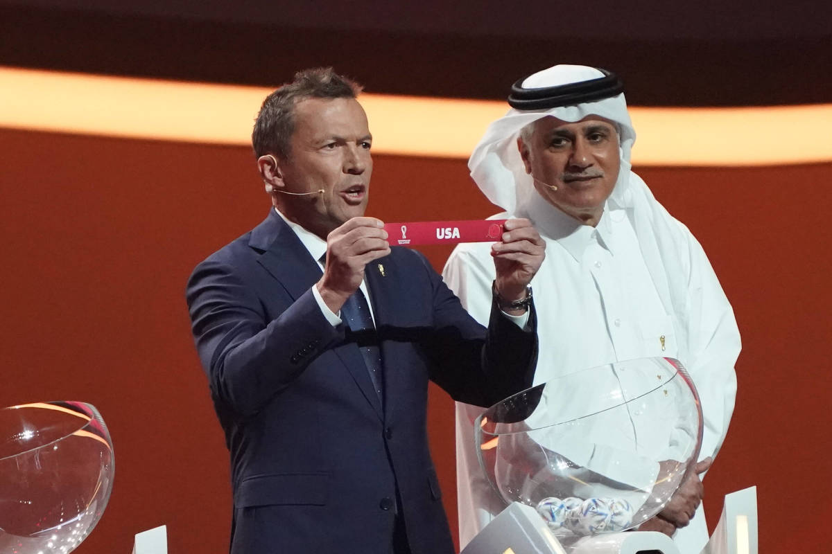 Lothar Matthaus holds up the name "USA" during the draw for the 2022 FIFA World Cup in Qatar