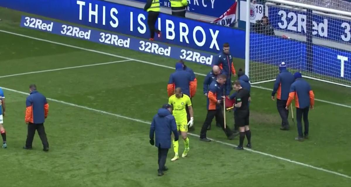 Celtic goalkeeper Joe Hart, Rangers ground staff and referee William Collum search for shards of broken glass at Ibrox