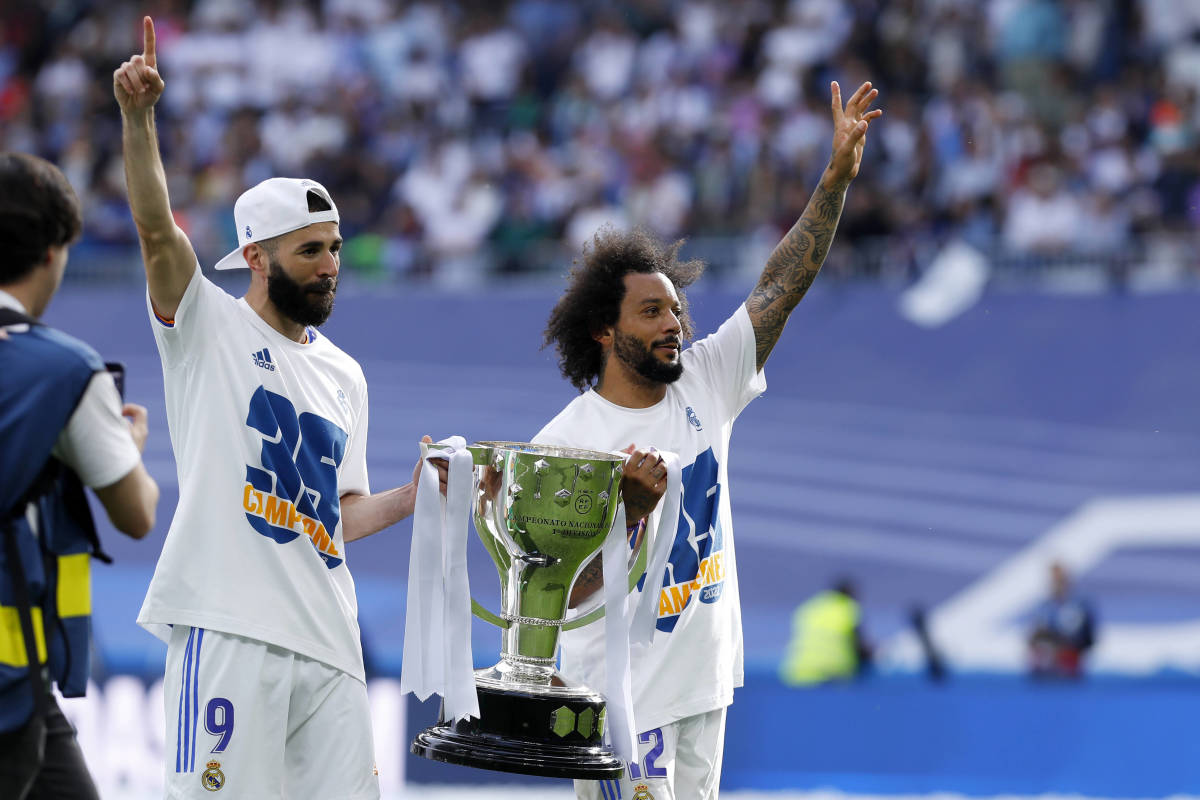Karim Benzema (left) and Marcelo lift the La Liga trophy after helping Real Madrid win their 35th Spanish league title in 2022