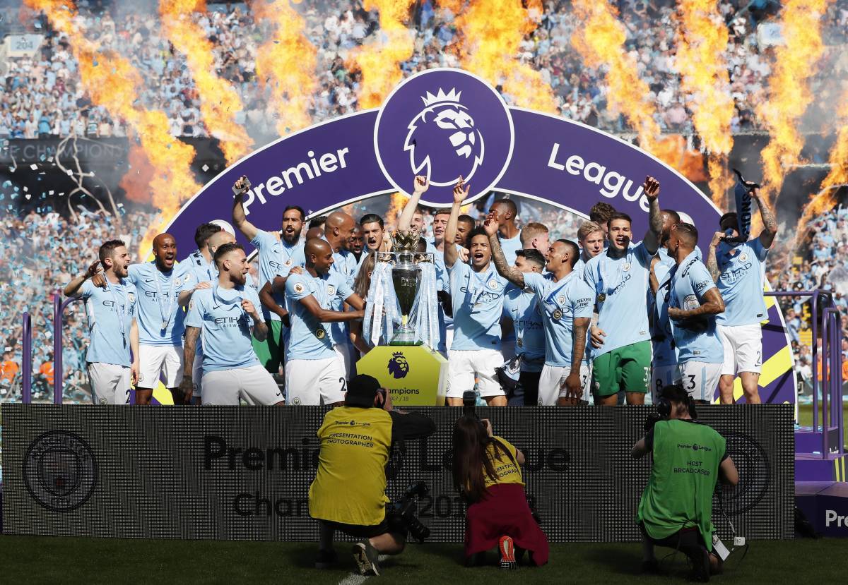 Manchester City's players pictured celebrating with the Premier League trophy at the end of the 2017/18 season - when they won a record-breaking 100 points