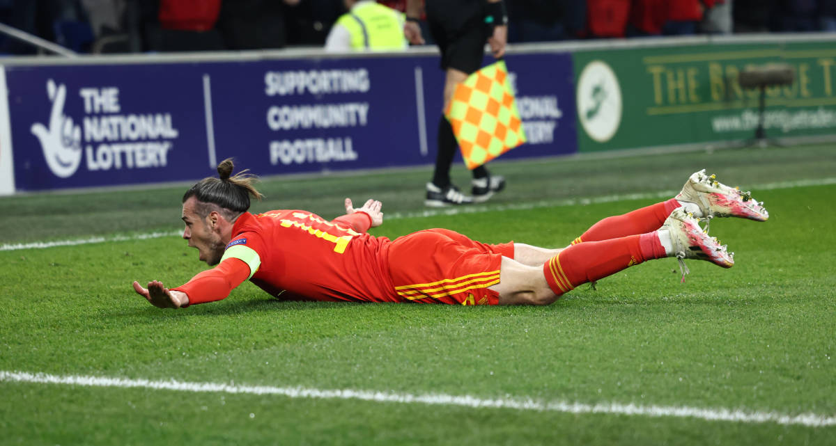 Gareth Bale slides on his chest after scoring a brilliant free-kick for Wales against Austria in a 2022 World Cup qualifier