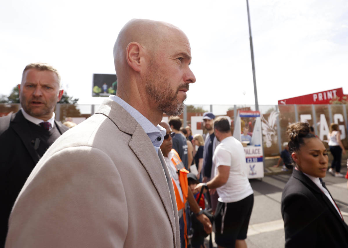 Erik ten Hag pictured outside Selhurst Park before Manchester United's game with Crystal Palace in May 2022 as his bodyguard (left) looks towards the camera