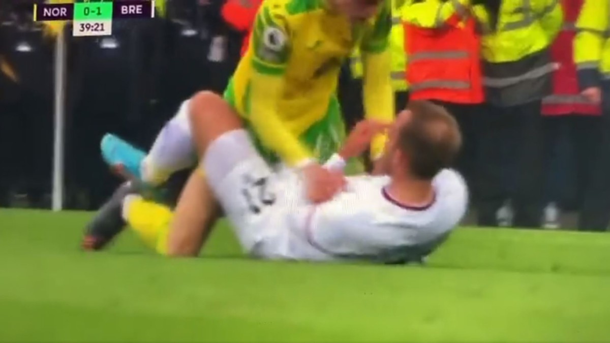 Brandon Williams grapples with Christian Eriksen before hugging him during Norwich vs Brentford