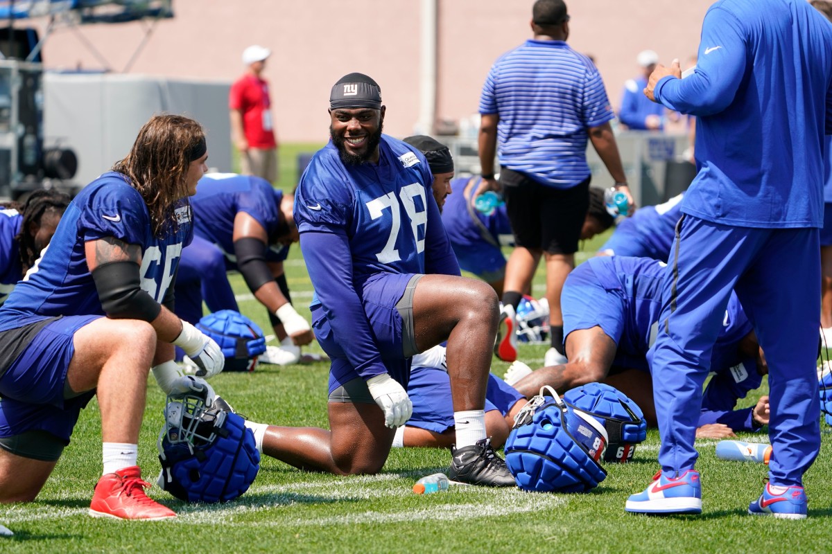 New York Giants offensive tackle Andrew Thomas (78) and guard Shane Lemieux (66) stretch at the end of the first day of training camp at Quest Diagnostics Training Center in East Rutherford on Wednesday, July 27, 2022.