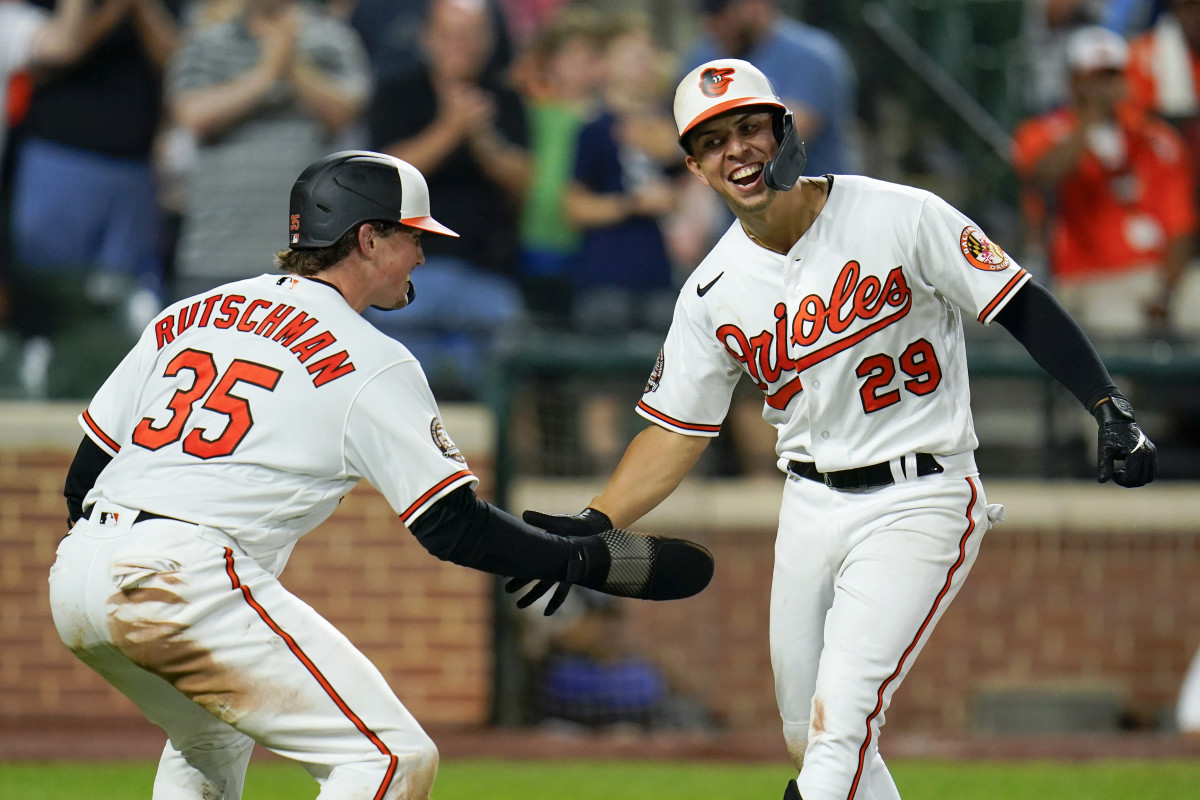 Baltimore Orioles’ Ramon Urias (29) is greeted near home plate by Adley Rutschman (35) after Urias’ two-run home run off Tampa Bay Rays relief pitcher Colin Poche scored both of them during the eighth inning of a baseball game, Tuesday, July 26, 2022, in Baltimore. The Orioles won 5-3.
