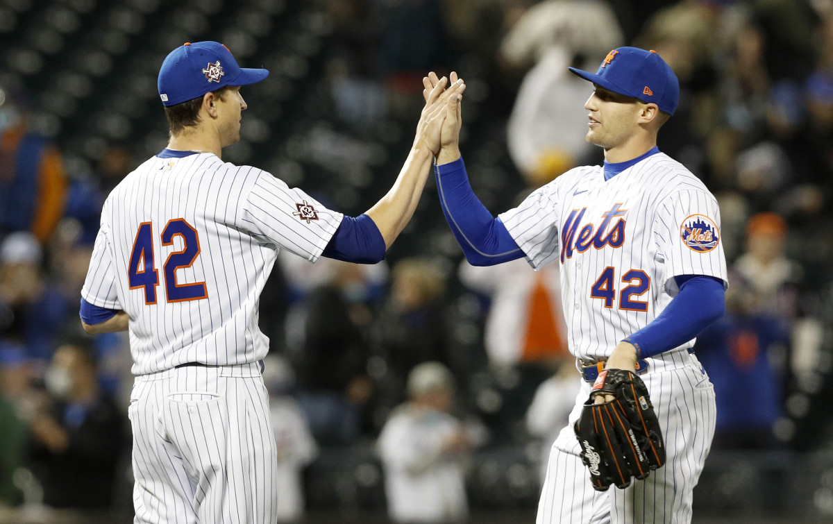 Jacob deGrom #48 (L) of the New York Mets celebrates his shutout  against the Washington Nationals with teammate Brandon Nimmo #9 at Citi Field on April 23, 2021 in New York City. All players are wearing the number 42 in honor of Jackie Robinson Day. The Mets defeated the Nationals 6-0.