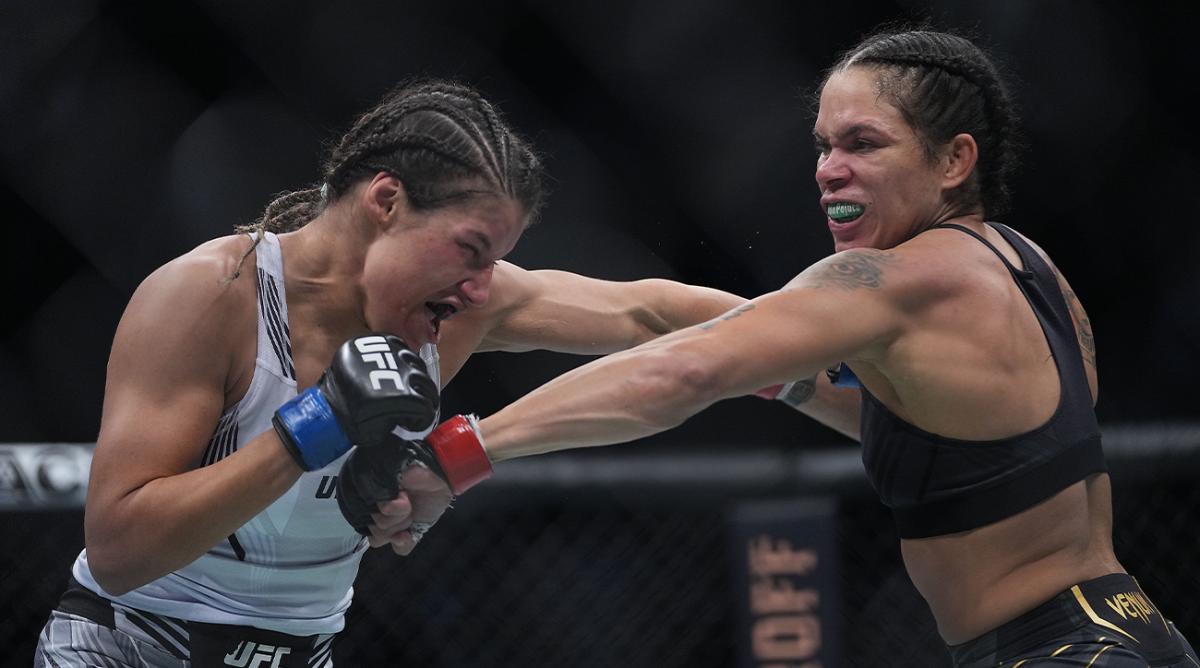 Dec 11, 2021; Las Vegas, Nevada, USA; Amanda Nunes moves in with a hit against Julianna Pena during UFC 269 at T-Mobile Arena.