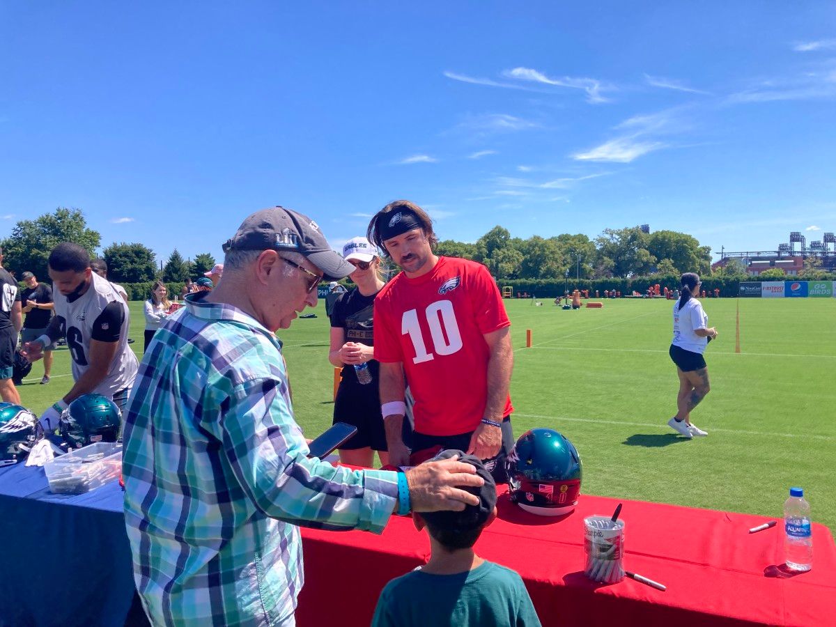Gardner Minshew meets a fan during practice on July 30, 2022