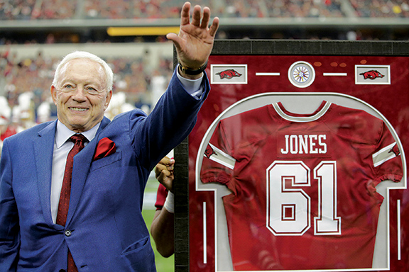 Dallas Cowboys owner Jerry Jones is presented with his Arkansas Razorbacks jersey at half time of the game against the Texas A&M Aggies at AT&T Stadium.