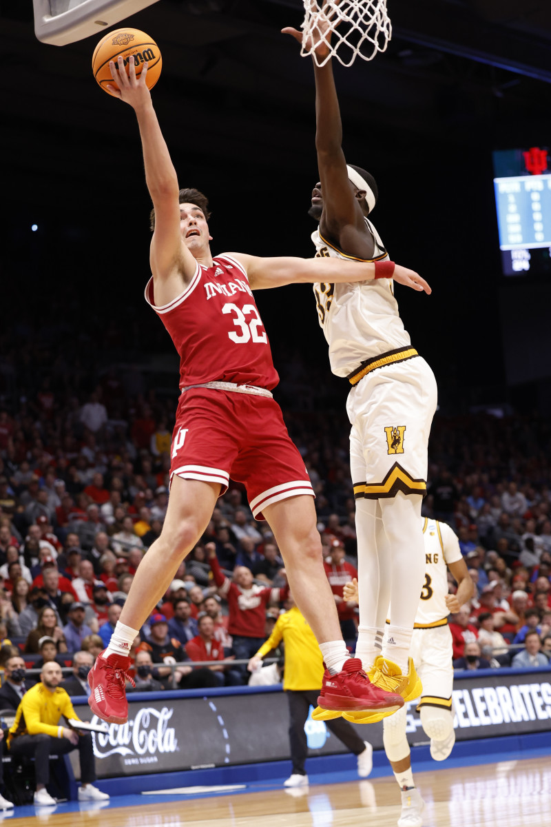 Mar 15, 2022; Dayton, OH, USA; Indiana Hoosiers guard Trey Galloway (32) goes to the basket defended by Wyoming Cowboys forward Graham Ike (33) during the First Four of the 2022 NCAA Tournament at UD Arena.