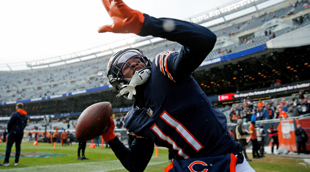 Chicago Bears wide receiver Darnell Mooney (11) throws the ball into the stands as he plays catch with fans during warmups before the game against the New York Giants at Soldier Field.