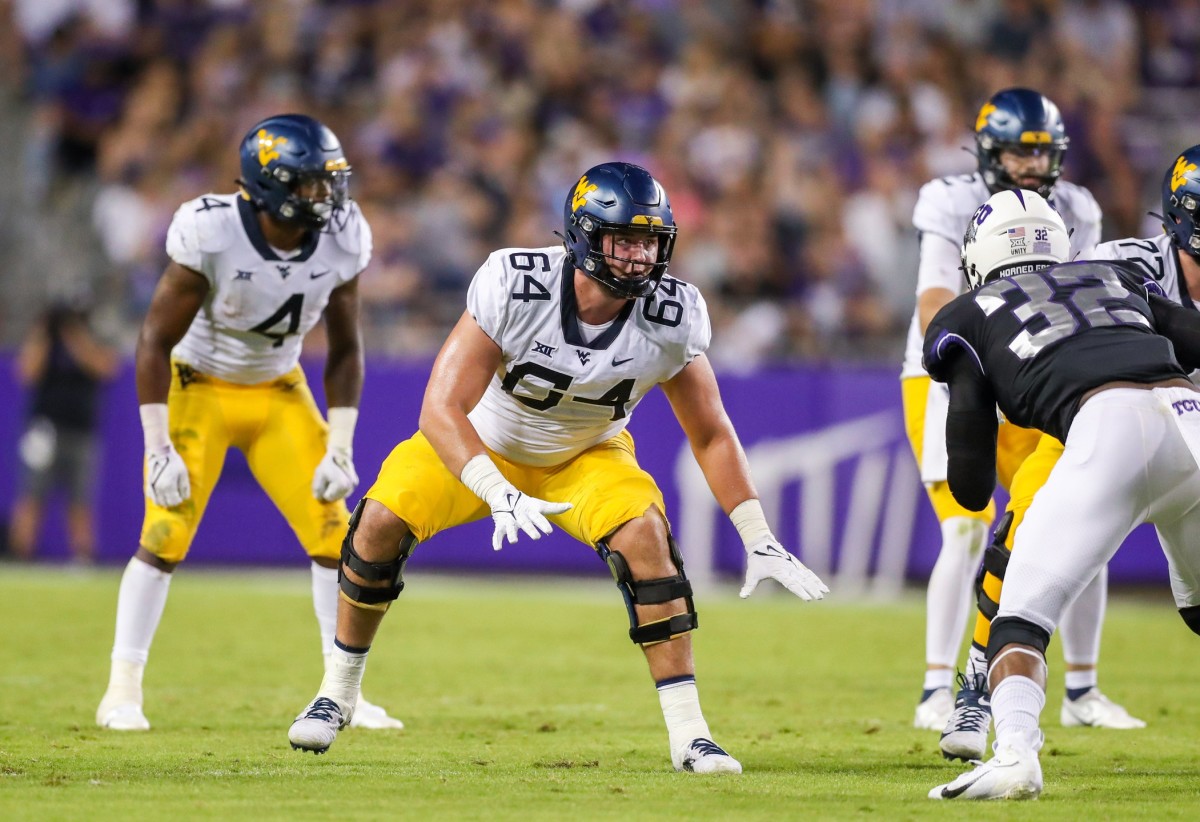 Oct 23, 2021; Fort Worth, Texas, USA; West Virginia Mountaineers offensive lineman Wyatt Milum (64) steps back to block during the third quarter against the TCU Horned Frogs at Amon G. Carter Stadium.