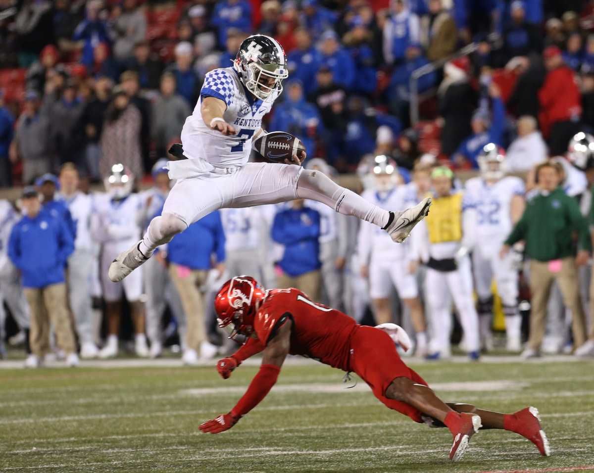 Kentucky's Will Levis jumps a player and runs for a first down against Louisville. Nov. 27, 2021 Louisvillekentucky 43