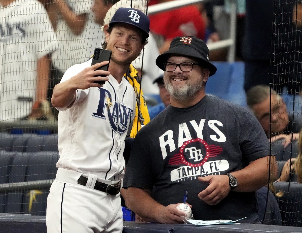 Jul 16, 2022; St. Petersburg, Florida, USA; Tampa Bay Rays right fielder Brett Phillips (35) poses with a fan before taking on the Baltimore Orioles at Tropicana Field. (Dave Nelson-USA TODAY Sports)