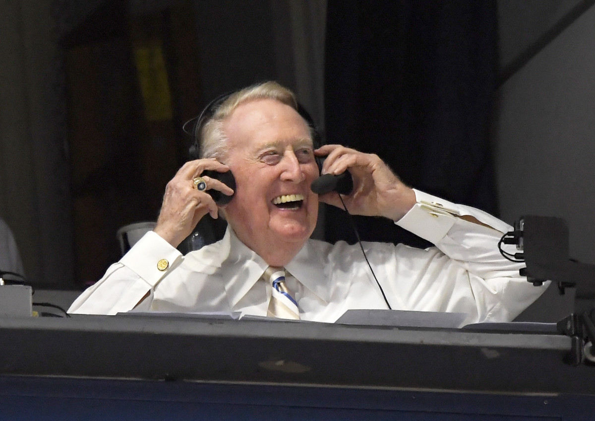 In this Monday, Sept. 19, 2016, file photo, Los Angeles Dodgers’ Hall of Fame announcer Vin Scully puts his headset on prior to a baseball game between the Los Angeles Dodgers and the San Francisco Giants in Los Angeles.   Scully, whose dulcet tones provided the soundtrack of summer while entertaining and informing Dodgers fans in Brooklyn and Los Angeles for 67 years, died Tuesday night, Aug. 2, 2022, the team said. He was 94.