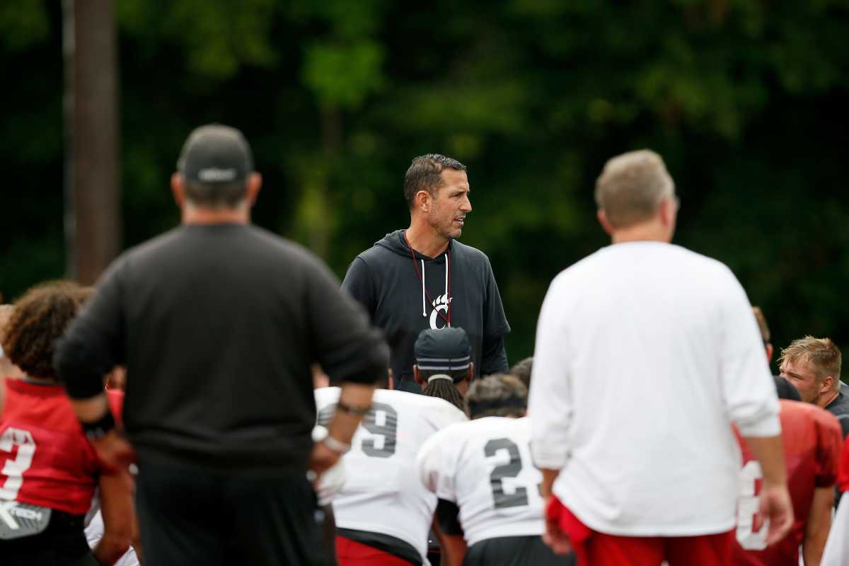 Cincinnati Bearcats head coach Luke Fickell calls a huddle to end the morning session during practice at the Higher Ground training facility in West Harrison, Ind., on Monday, Aug. 9, 2021. Cincinnati Bearcats Football Camp