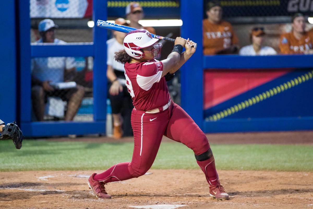 Jun 9, 2022; Oklahoma City, Oklahoma, USA; Oklahoma Sooners utility Jocelyn Alo (78) hits the ball for a single during the sixth inning against the Texas Longhorns in game two of the 2022 Women's College World Series finals at USA Softball Hall of Fame Stadium. Oklahoma won 10-5 to win the National Championship.