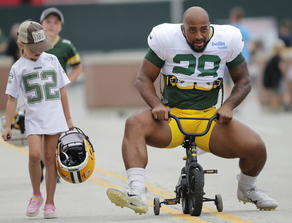 Running back AJ Dillon takes a slightly undersized bike to Packers training camp. (Dan Powers/USA Today Sports Images)