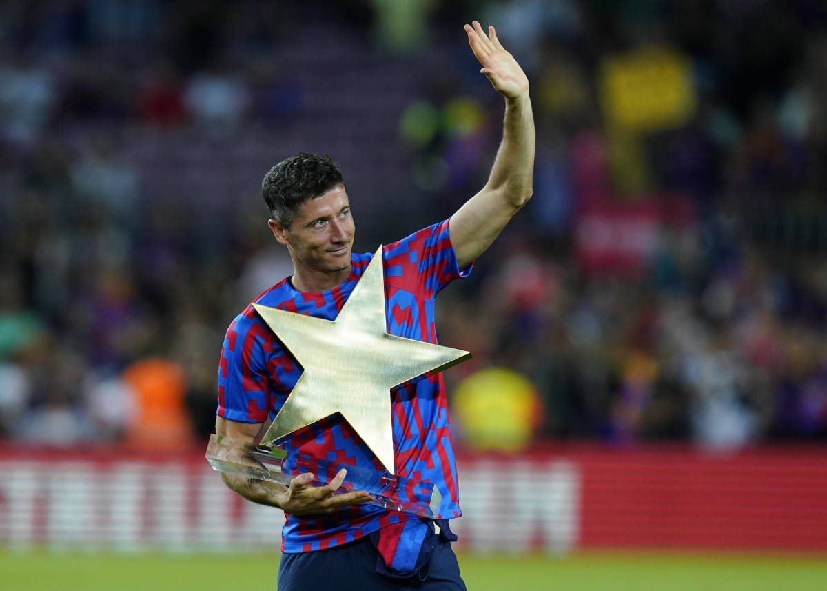 Robert Lewandowski pictured lifting a star-shaped MVP trophy after helping Barcelona beat Pumas UNAM 6-0 at the Camp Nou in August 2022