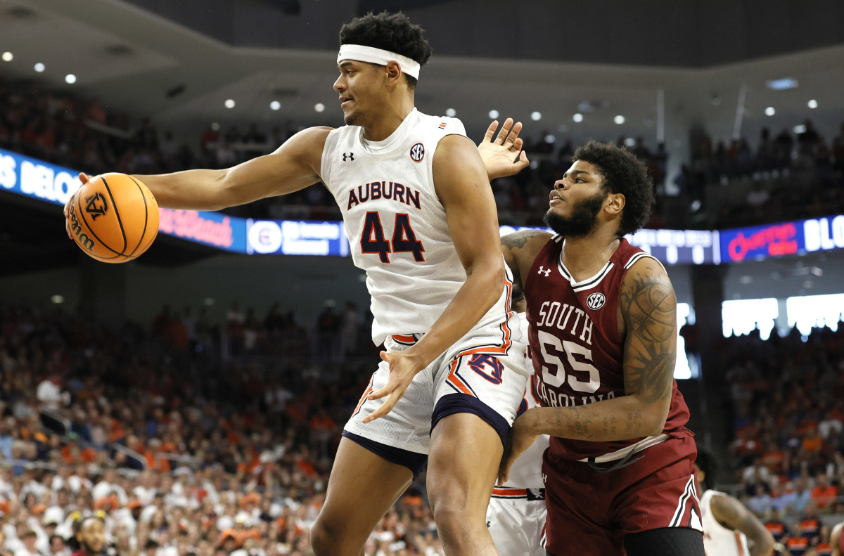 Mar 5, 2022; Auburn, Alabama, USA; Auburn Tigers center Dylan Cardwell (44) grabs a rebound against South Carolina Gamecocks forward Ta'Quan Woodley (55) during the first half at Neville Arena. Mandatory Credit: John Reed-USA TODAY Sports
