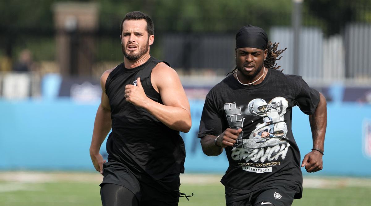 Aug 4, 2022; Canton, Ohio, USA; Las Vegas Raiders receiver Davante Adams (left) and quarterback Derek Carr run before the game against the Jacksonville Jaguars at Tom Benson Hall of Fame Stadium.