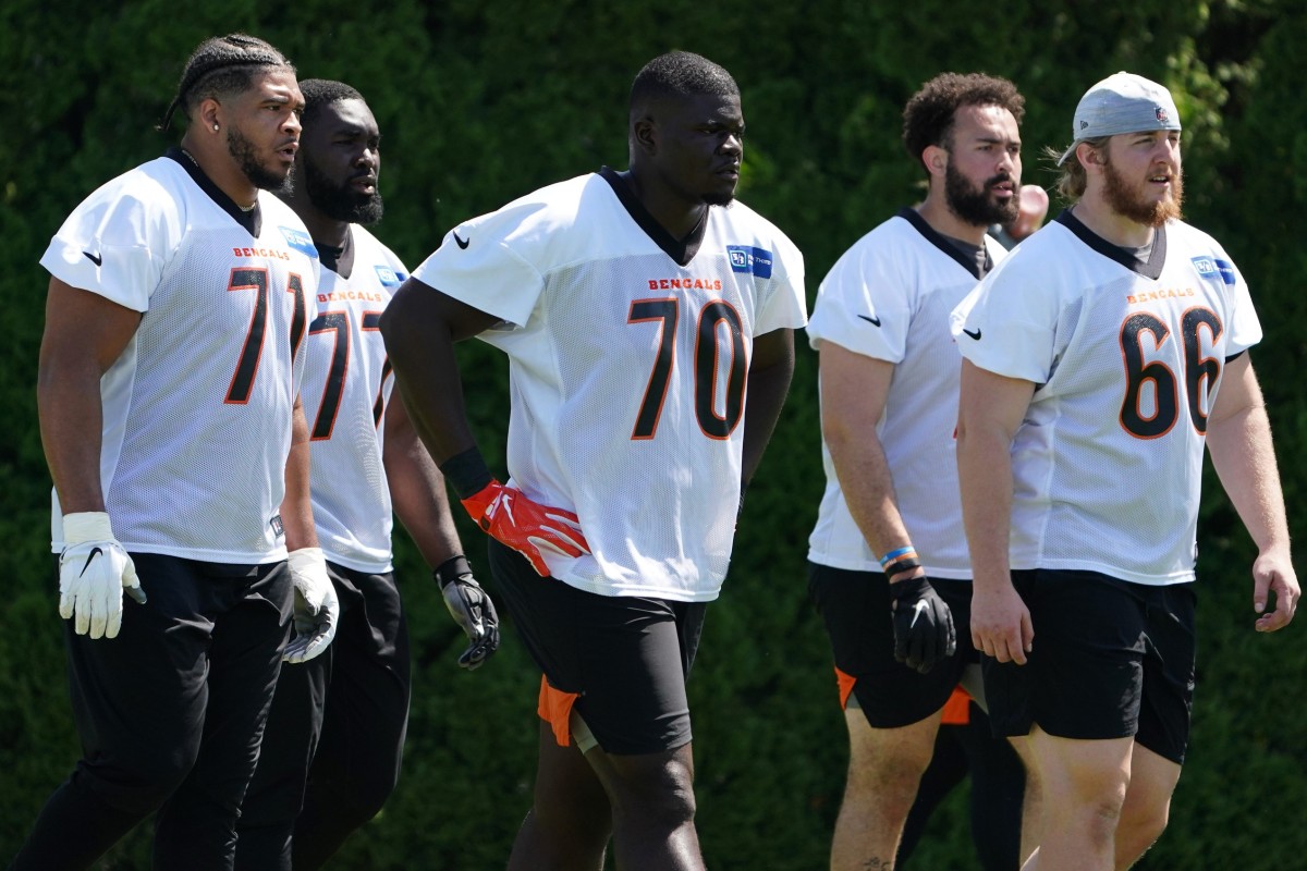 From left: Offensive tackle La'el Collins (71), offensive guard Hakeem Adeniji, offensive tackle D'Ante Smith, offensive tackle Devin Cochran (77) and offensive guard Alex Cappa (66) walk to the next drill during practice, Tuesday, May 17, 2022, at the Paul Brown Stadium practice fields in Cincinnati. Cincinnati Bengals Practice May 17 0102