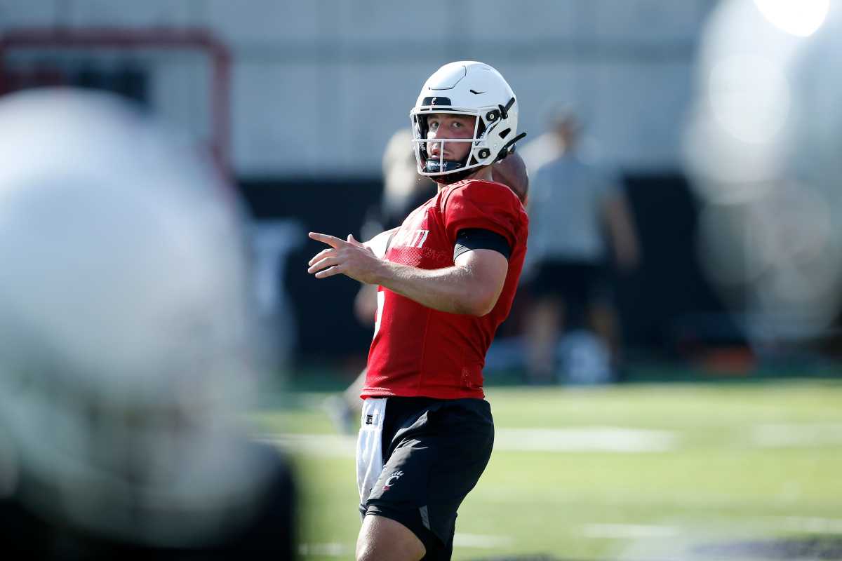 Bearcats quarterback Ben Bryant (6) drops back to throw during the first day of preseason training camp at the University of Cincinnati s Sheakley Athletic Complex in Cincinnati on Wednesday, Aug. 3, 2022. Bearcats Football Camp